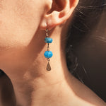 Load image into Gallery viewer, The Yoga Retreat in Bali Earrings is handcrafted from the 14K Gold-filled wire hook, natural peacock blue faceted Apatite bead with dazzling brass charms.
