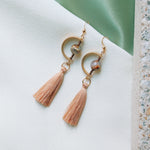 Load image into Gallery viewer, The Twilight Zone in Romania Earrings is handcrafted from the 14K Gold-filled wire hook, premium Japanese silk thread, Natural brown opal 8mm round Smooth opal, with dazzling brass charm.
